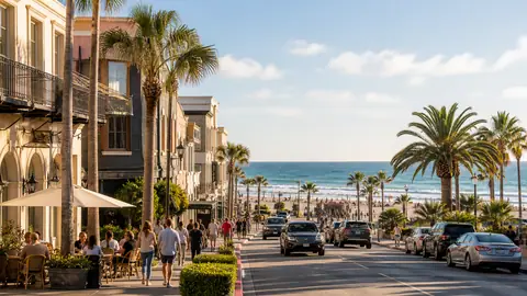 Photoreal hybrid city-and-beach getaway scene with urban waterfront street opening toward sunlit shoreline