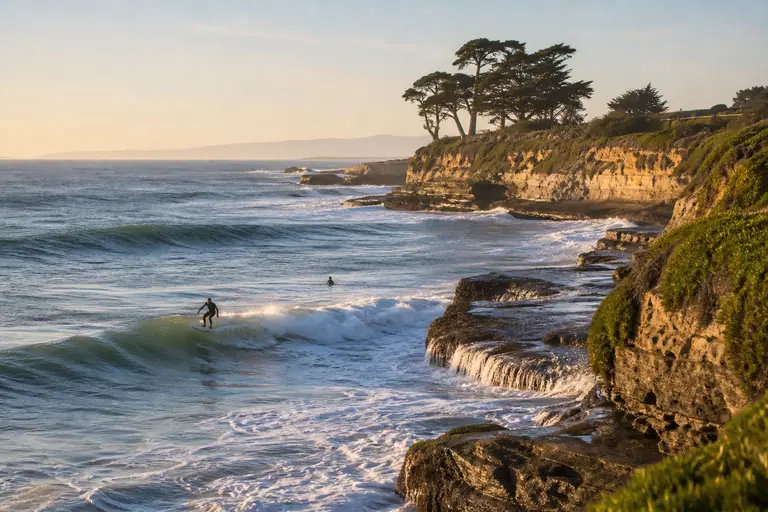 Photoreal Santa Cruz scene with surfers at Steamer Lane and the coastal cliffs