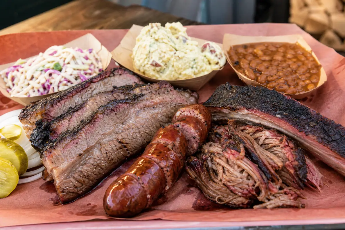 Photoreal dining or food scene representing La Barbecue in Austin