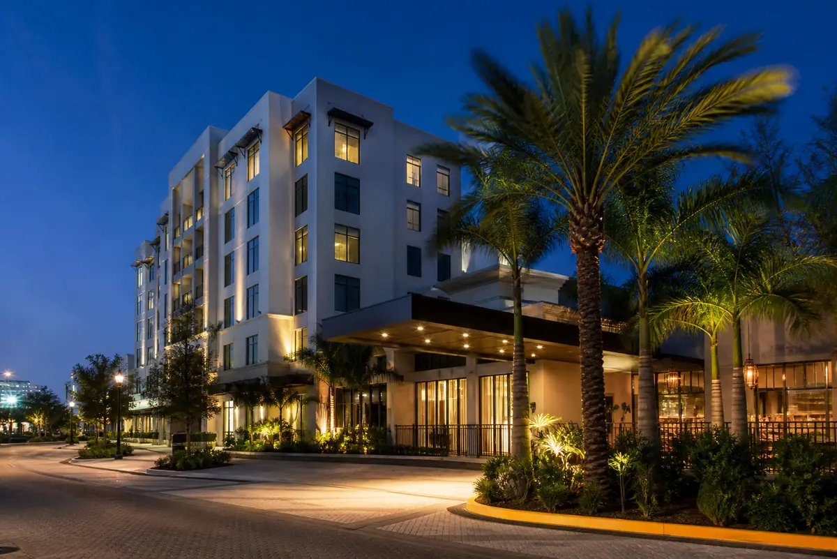 Photoreal travel-editorial view of Hotel Indigo Fort Myers Downtown River District in Fort Myers, Florida