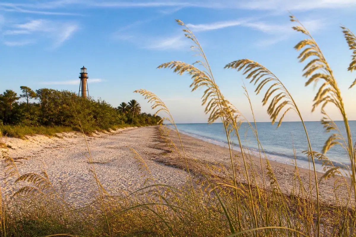 Photoreal travel-editorial view of Sanibel Lighthouse Beach Park in Fort Myers, Florida