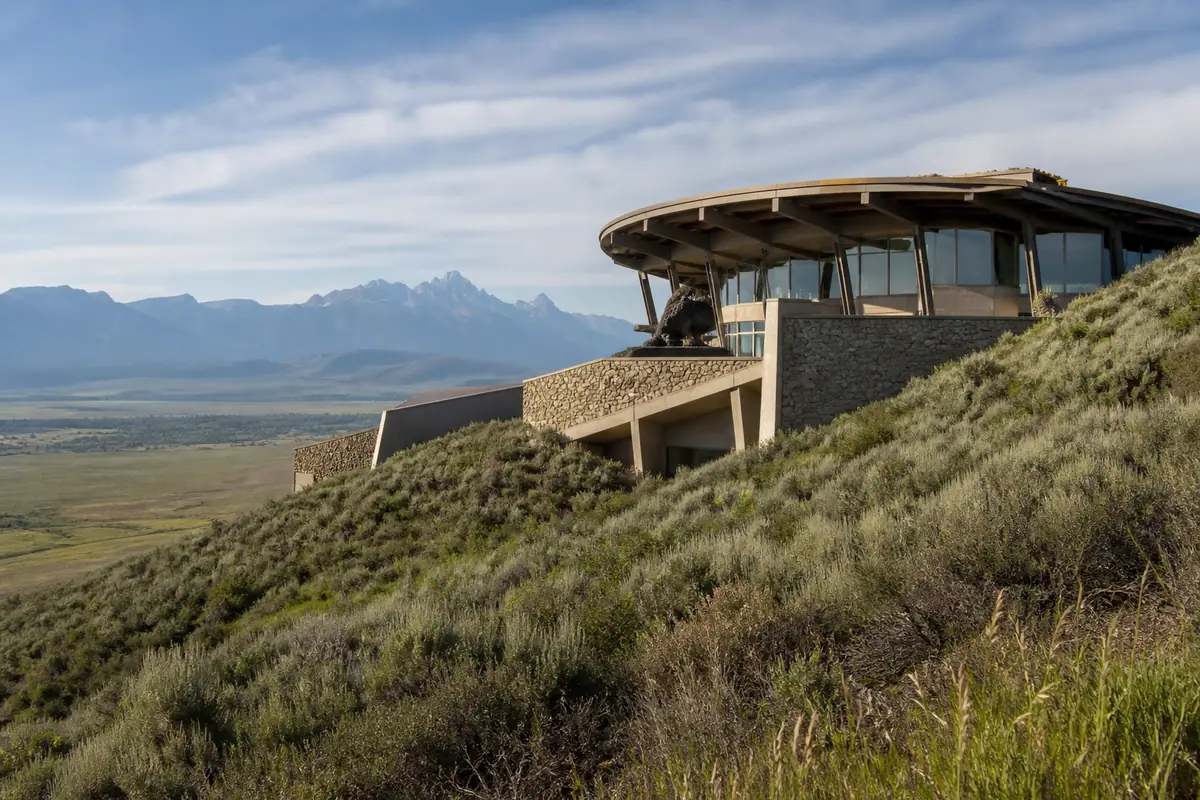 Photorealistic travel-editorial view of National Museum of Wildlife Art in Jackson, Wyoming