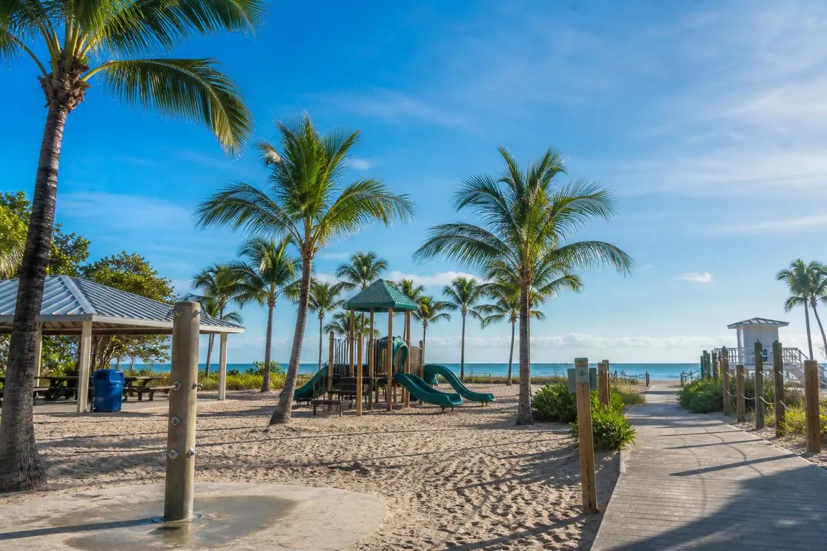 Photoreal travel-editorial view of Lowdermilk Park in Naples, Florida