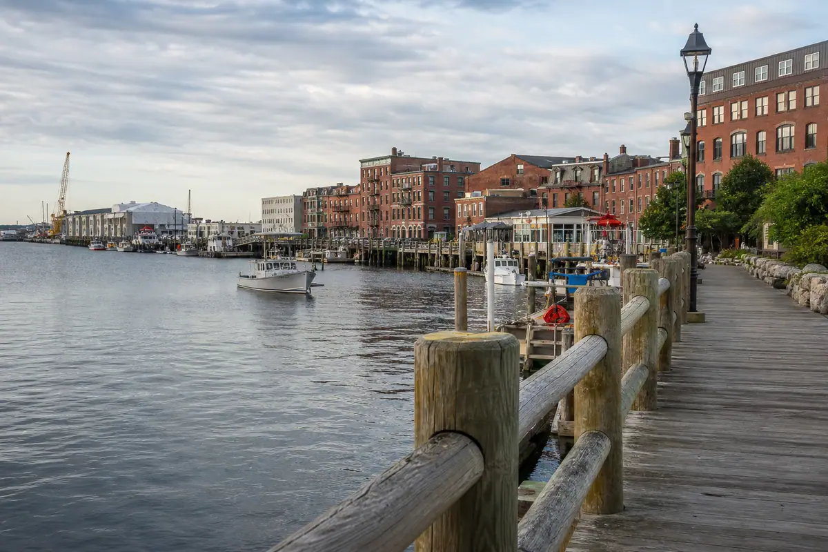 Photoreal travel-editorial view of Commercial Street Waterfront Walk in Portland, Maine