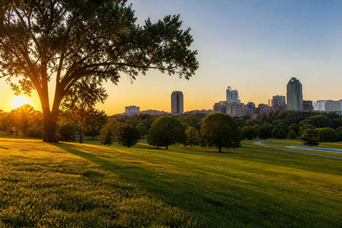 Photorealistic travel-editorial view of Dorothea Dix Park in Raleigh, North Carolina