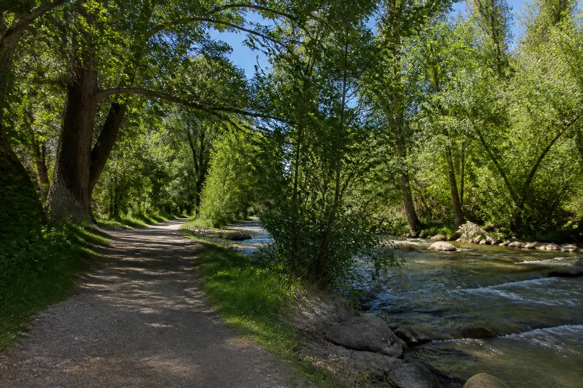 Photorealistic travel-editorial view of Idlewild Park and Truckee River Path in Reno, Nevada