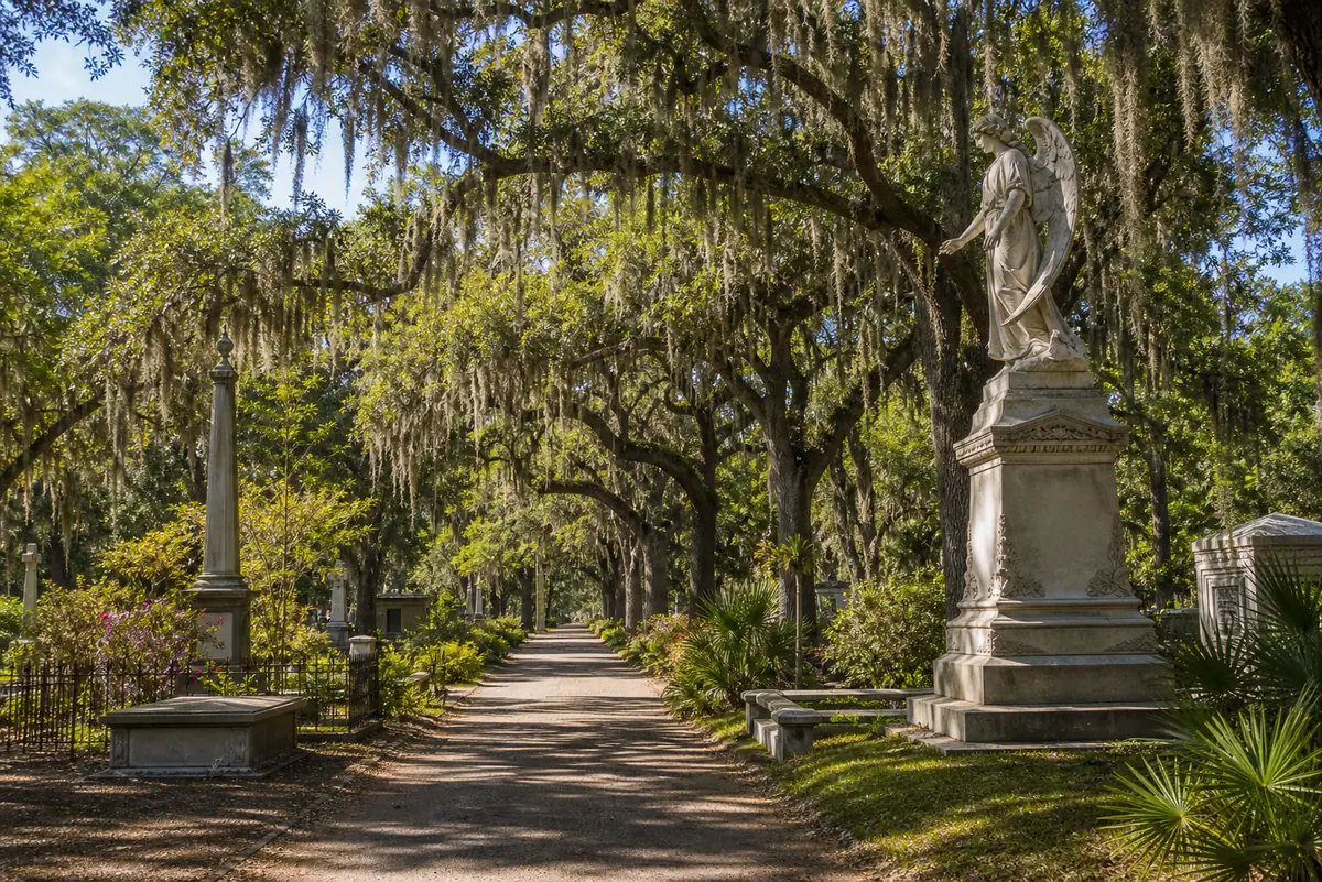 Photoreal Bonaventure Cemetery avenue with moss-draped oaks and sculptural monuments near Savannah