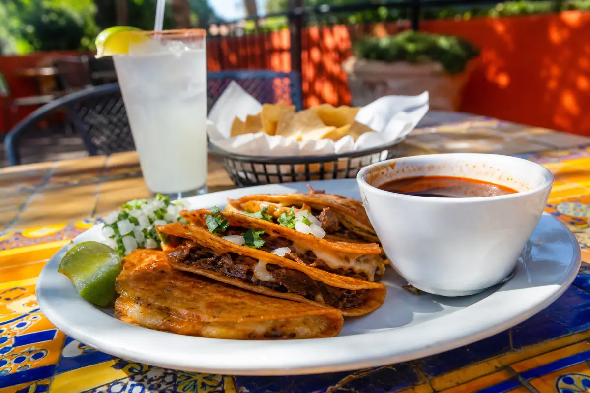 Photoreal travel-editorial view of Rollies Mexican Patio in Tucson, Arizona